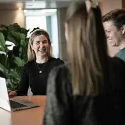 En gruppe mennesker som ser på en bærbar datamaskin